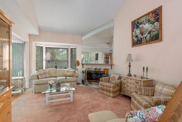 carpeted living area featuring a tile fireplace