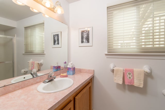bathroom featuring a stall shower and vanity
