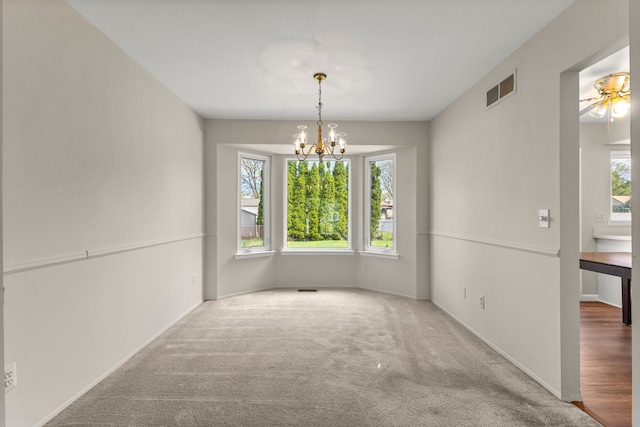 unfurnished dining area with a chandelier, carpet floors, and baseboards
