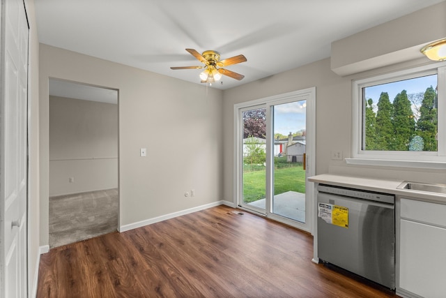 kitchen featuring stainless steel dishwasher, dark wood-style floors, light countertops, white cabinetry, and a ceiling fan