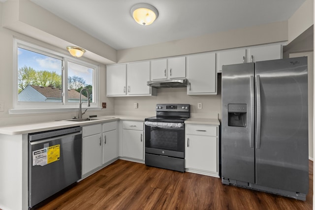 kitchen with stainless steel appliances, a sink, light countertops, and under cabinet range hood
