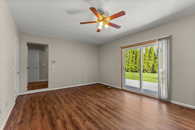 spare room featuring wood finished floors, ceiling fan, and baseboards