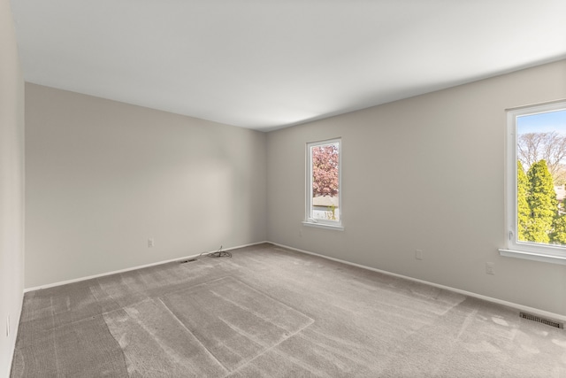 carpeted spare room with baseboards