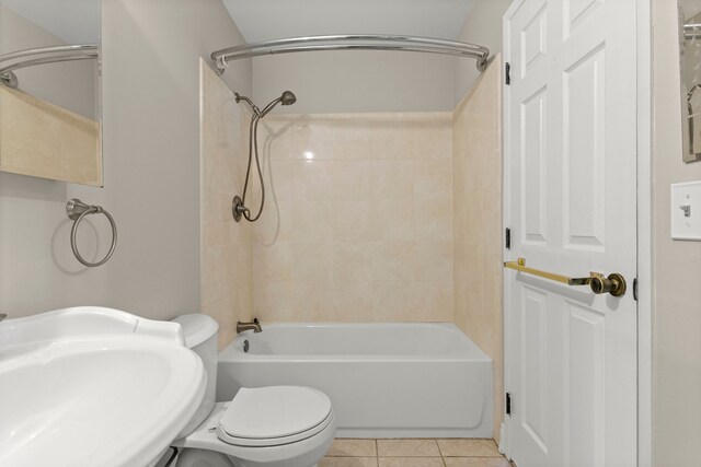 bathroom with a sink, tile patterned flooring, toilet, and washtub / shower combination