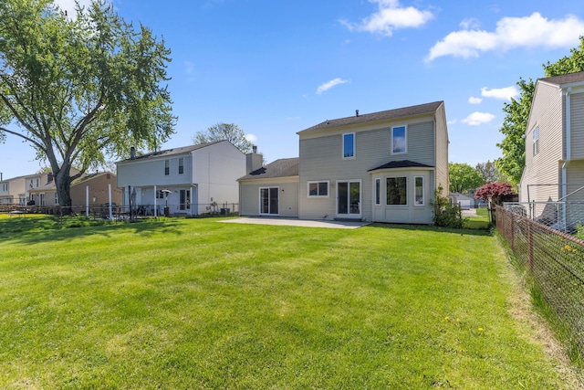 rear view of property featuring a patio area