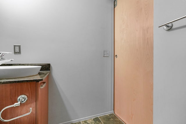 bathroom with vanity and stone finish flooring