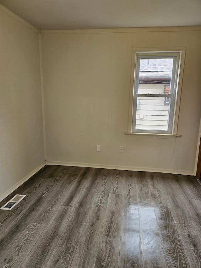 spare room with visible vents and wood finished floors