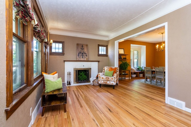 320 E Farnum Ave, Royal Oak, MI 48067 - sitting room featuring wood-type flooring, a chandelier, a fireplace, and baseboards