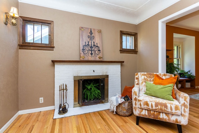 320 E Farnum Ave, Royal Oak, MI 48067 - living area with wood finished floors, a brick fireplace, baseboards, and crown molding