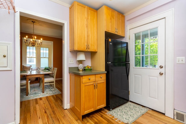 320 E Farnum Ave, Royal Oak, MI 48067 - kitchen with freestanding refrigerator, a chandelier, crown molding, light wood-type flooring, and dark countertops