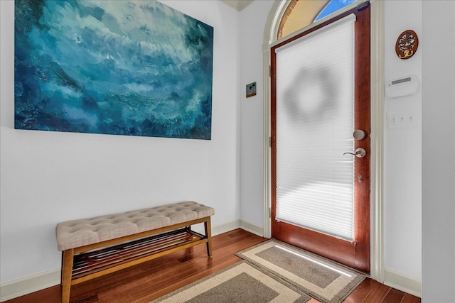 entryway with wood finished floors and baseboards