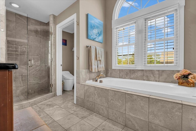 full bath featuring a shower stall, a garden tub, and toilet