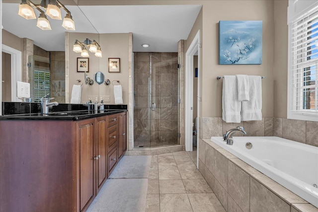 bathroom with a stall shower, a garden tub, double vanity, a chandelier, and tile patterned floors