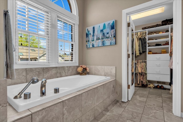 full bath featuring a walk in closet and a bath