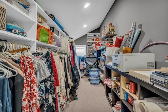 walk in closet featuring carpet and vaulted ceiling