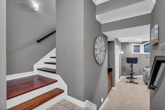 stairs with ornamental molding and baseboards