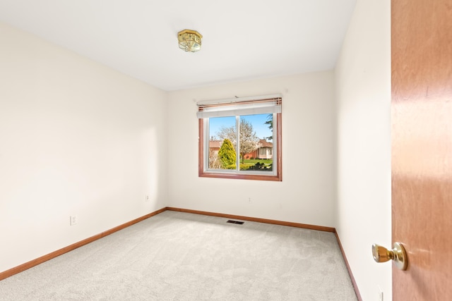 carpeted empty room with baseboards and visible vents