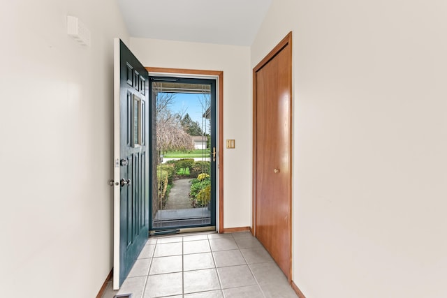entryway featuring baseboards and light tile patterned floors