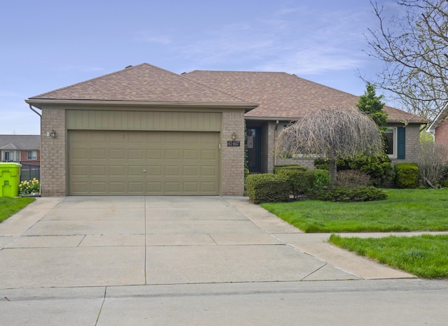 ranch-style home with brick siding, concrete driveway, a garage, a front lawn, and a shingled roof