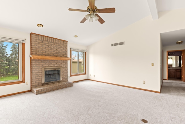 unfurnished living room featuring carpet, baseboards, visible vents, and a wealth of natural light