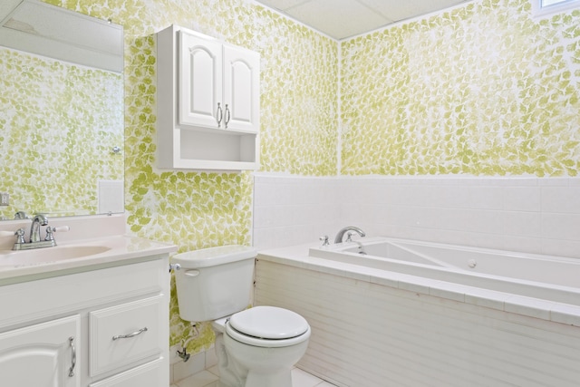 bathroom with toilet, vanity, wallpapered walls, and a bath