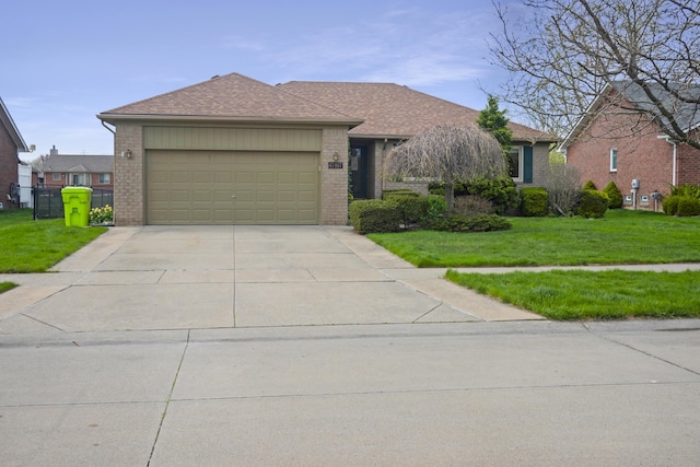 ranch-style home with concrete driveway, a front yard, brick siding, and a garage