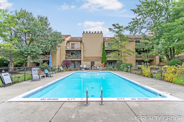 pool with fence and a patio