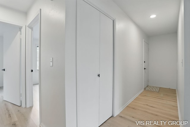 hallway with recessed lighting, baseboards, and light wood-style floors