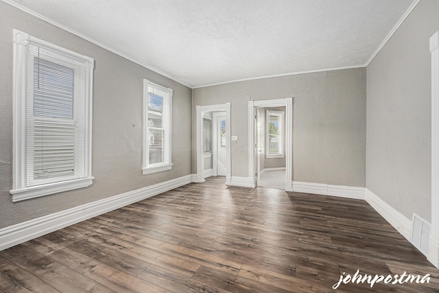 1108/1110 Muskegon Ave NW, Grand Rapids, MI 49504 - unfurnished room with ornamental molding, baseboards, hardwood / wood-style floors, and visible vents