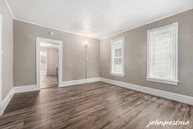 1108/1110 Muskegon Ave NW, Grand Rapids, MI 49504 - unfurnished bedroom featuring crown molding, a textured ceiling, dark wood-type flooring, and baseboards