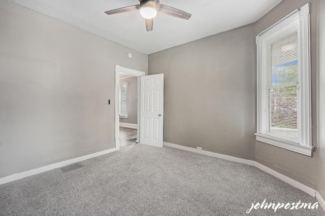 1108/1110 Muskegon Ave NW, Grand Rapids, MI 49504 - carpeted empty room with visible vents, baseboards, and ceiling fan