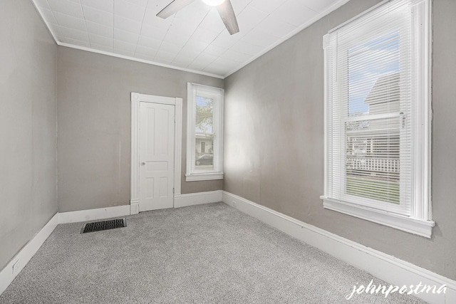1108/1110 Muskegon Ave NW, Grand Rapids, MI 49504 - unfurnished room with ornamental molding, visible vents, carpet flooring, a ceiling fan, and baseboards