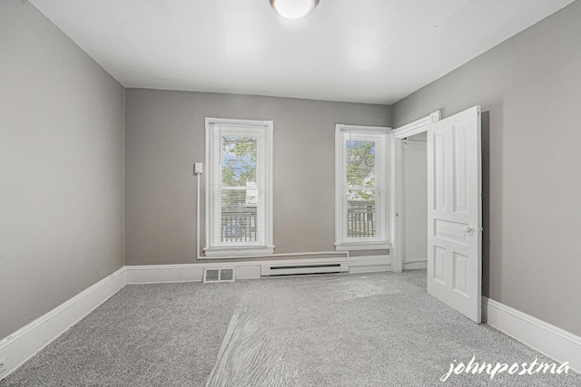 1108/1110 Muskegon Ave NW, Grand Rapids, MI 49504 - carpeted spare room with baseboards, a baseboard radiator, and visible vents
