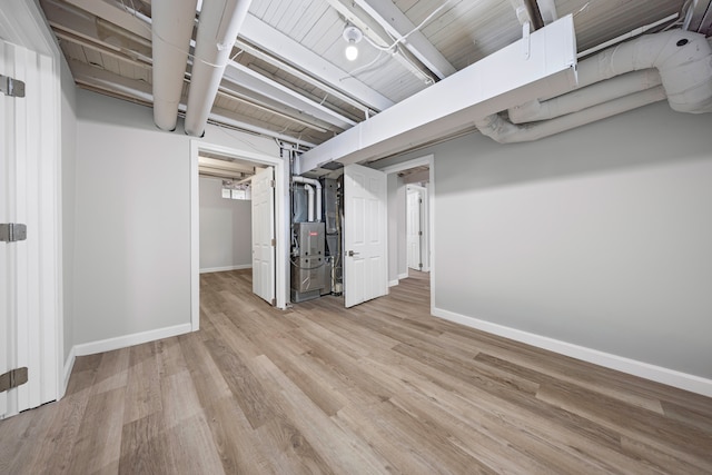 91 S Josephine Ave, Waterford, MI 48328 - finished below grade area featuring baseboards, light wood-style floors, and heating unit