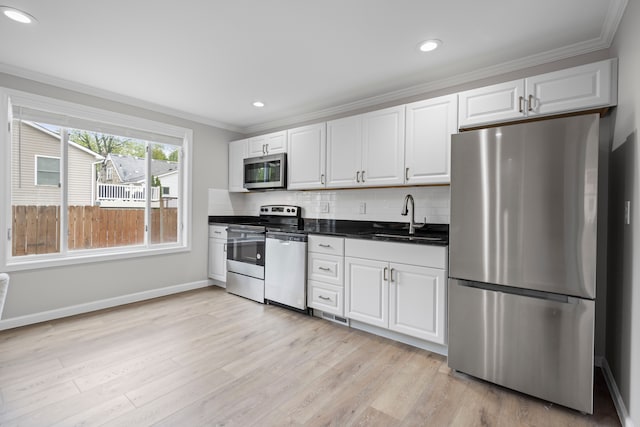 91 S Josephine Ave, Waterford, MI 48328 - kitchen featuring stainless steel appliances, ornamental molding, a sink, white cabinetry, and baseboards
