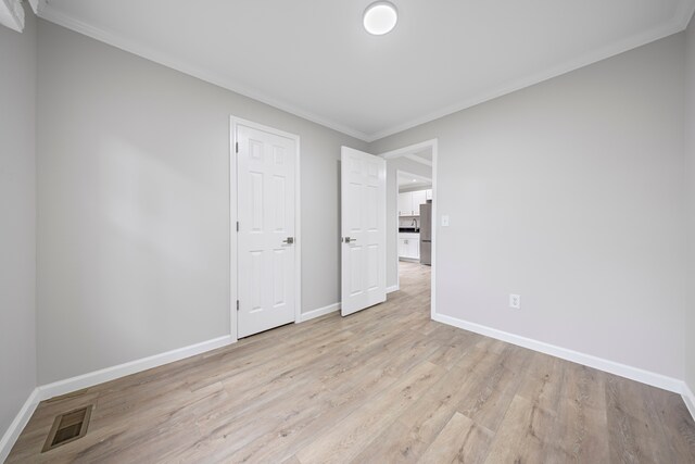 91 S Josephine Ave, Waterford, MI 48328 - spare room with baseboards, light wood finished floors, and ornamental molding