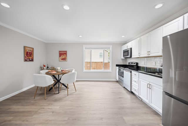 91 S Josephine Ave, Waterford, MI 48328 - kitchen featuring appliances with stainless steel finishes, ornamental molding, a sink, baseboards, and white cabinets