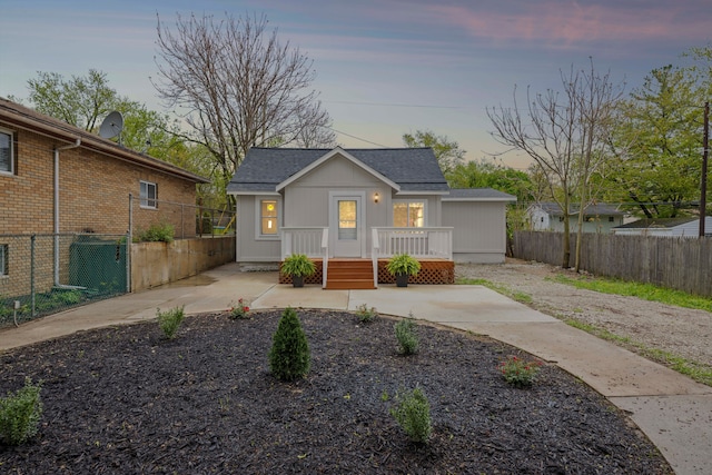 91 S Josephine Ave, Waterford, MI 48328 - bungalow with a fenced backyard, a patio, and a shingled roof
