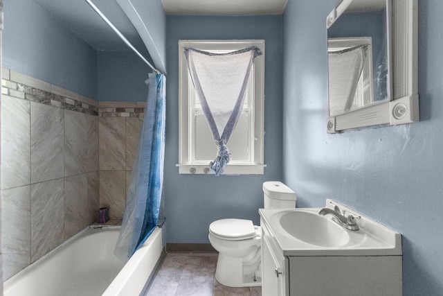 bathroom featuring toilet, baseboards, shower / tub combo, and vanity
