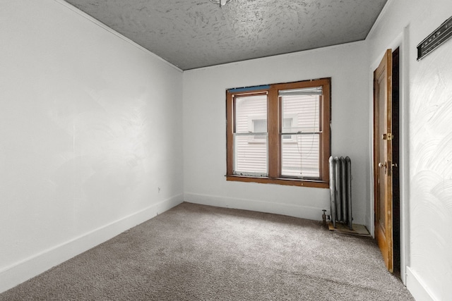 unfurnished room featuring a textured ceiling, radiator, baseboards, and carpet