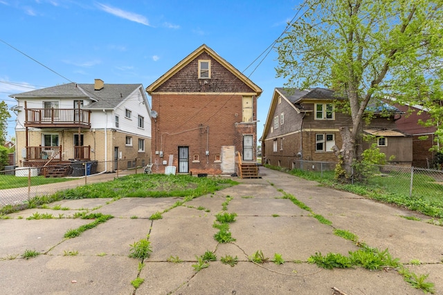 exterior space featuring fence and brick siding