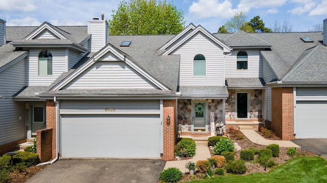 6480 Scenic Pines Ct, Clarkston, MI 48346 - view of front of house with asphalt driveway, a garage, a chimney, and a shingled roof