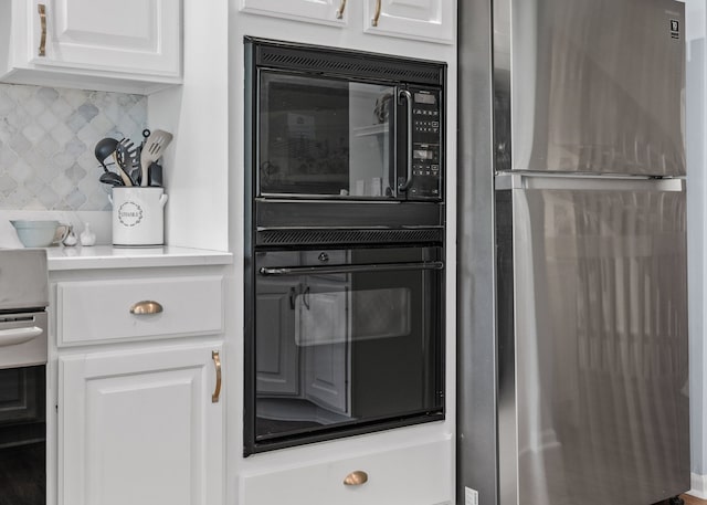 6480 Scenic Pines Ct, Clarkston, MI 48346 - kitchen featuring freestanding refrigerator, black microwave, white cabinets, backsplash, and range