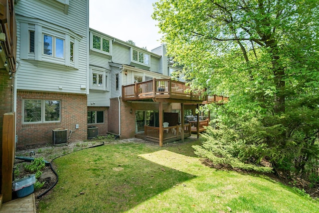 6480 Scenic Pines Ct, Clarkston, MI 48346 - rear view of house with a deck, brick siding, a yard, and central AC unit