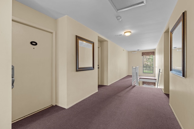 corridor featuring an upstairs landing, baseboards, and carpet floors