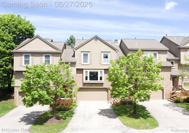 4184 Colorado Ln Unit 117, West Bloomfield, MI 48322 - view of front of house with a garage, asphalt driveway, and a residential view