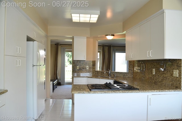 4184 Colorado Ln Unit 117, West Bloomfield, MI 48322 - kitchen featuring freestanding refrigerator, black electric cooktop, white cabinetry, and backsplash