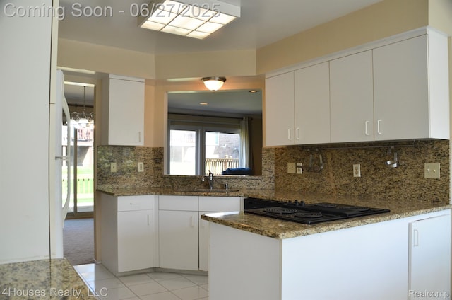 4184 Colorado Ln Unit 117, West Bloomfield, MI 48322 - kitchen featuring black electric stovetop, white cabinets, light tile patterned floors, dark stone counters, and decorative backsplash