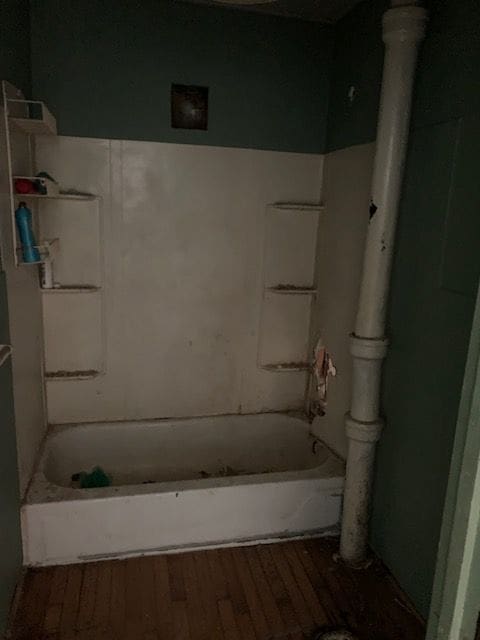 full bathroom with bathtub / shower combination and wood finished floors