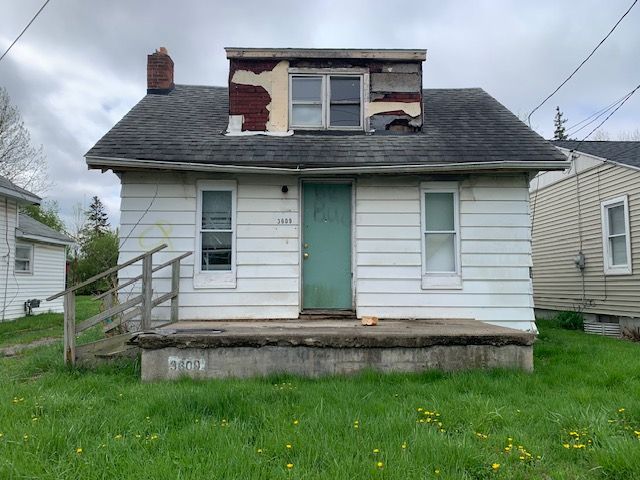 exterior space featuring roof with shingles and a chimney